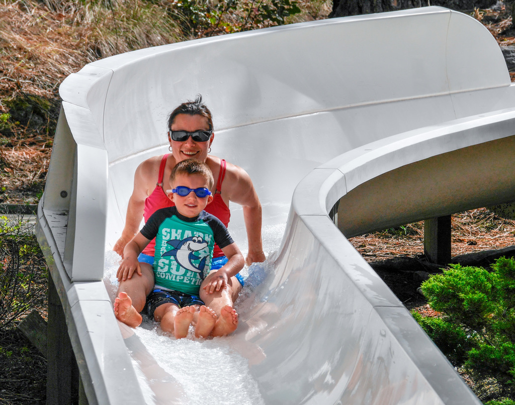 Mother and child going down the water slide