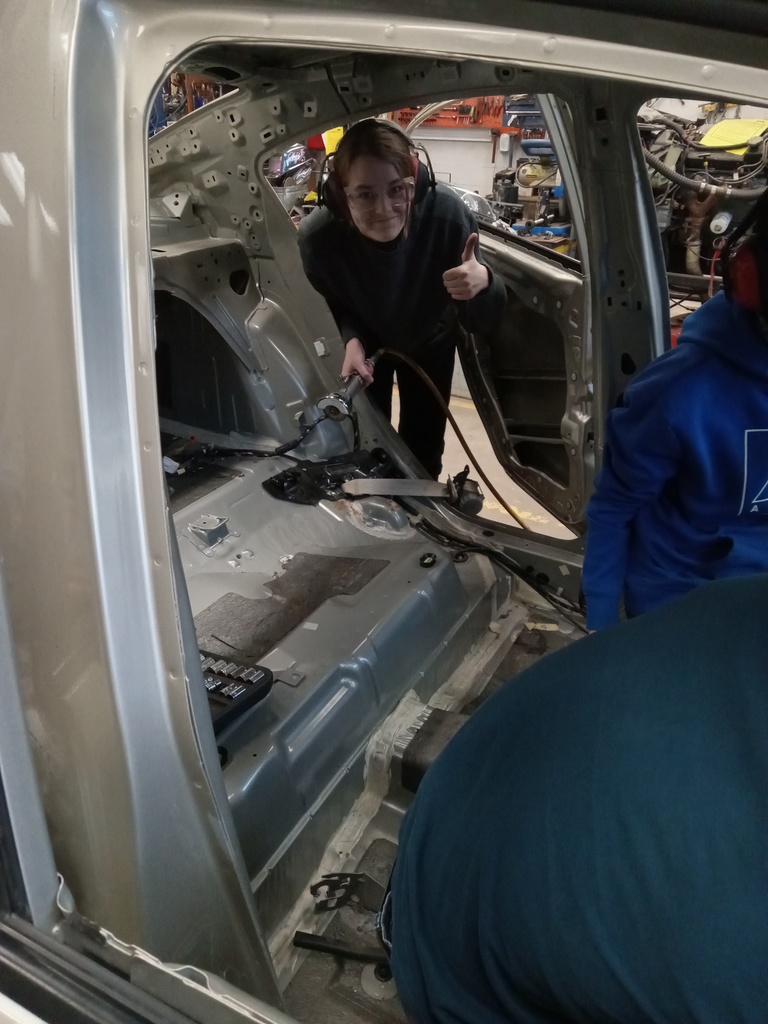 Using cut-off tools to remove rusted seat belt bolts.