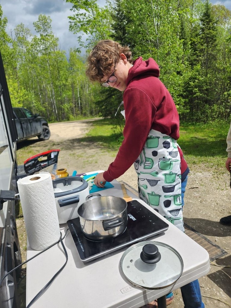 teen boy cooking camping