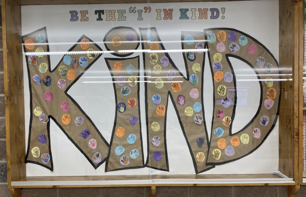A poster that says "Be the I in Kind!"